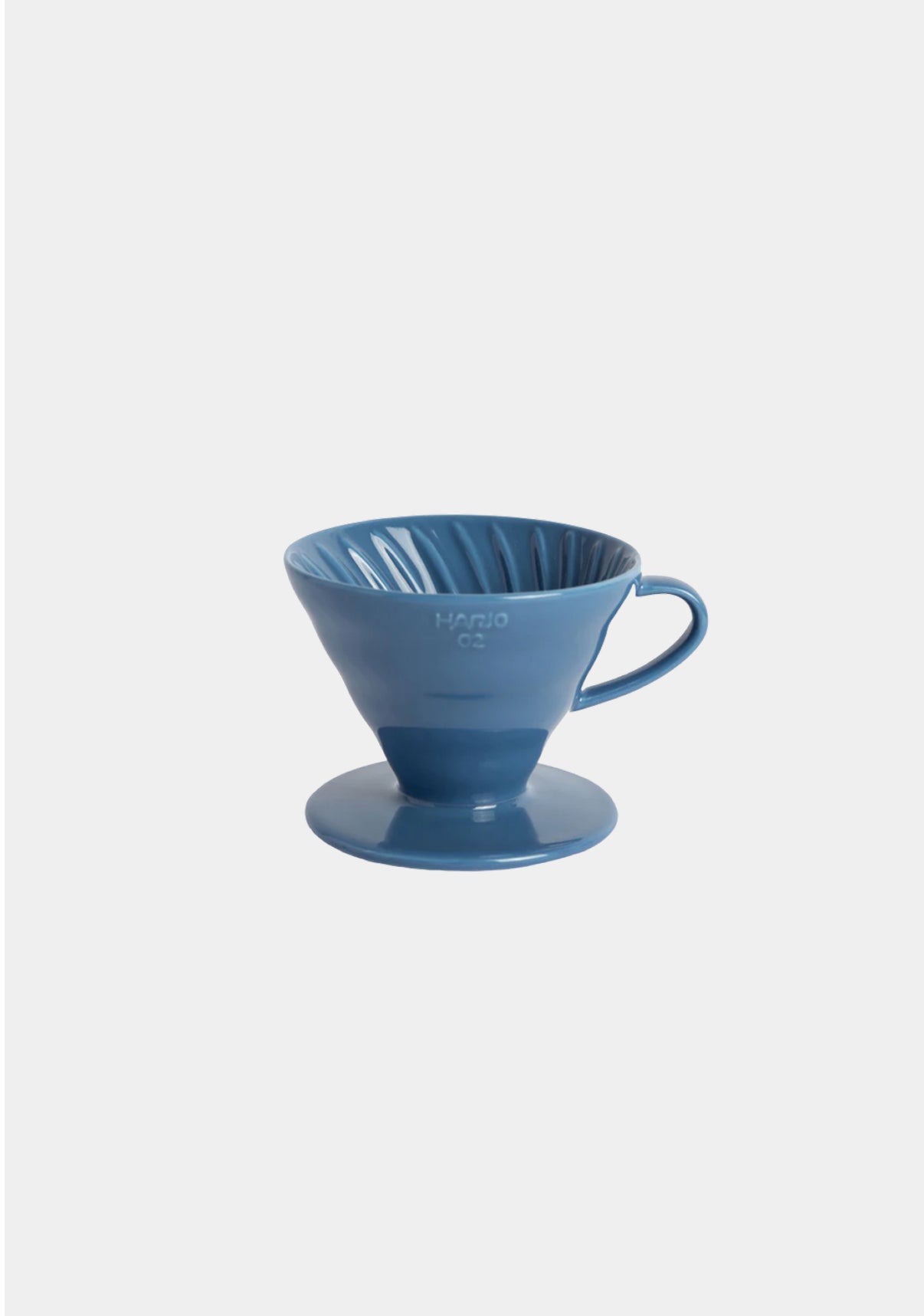 Blue ceramic coffee dripper on a white background