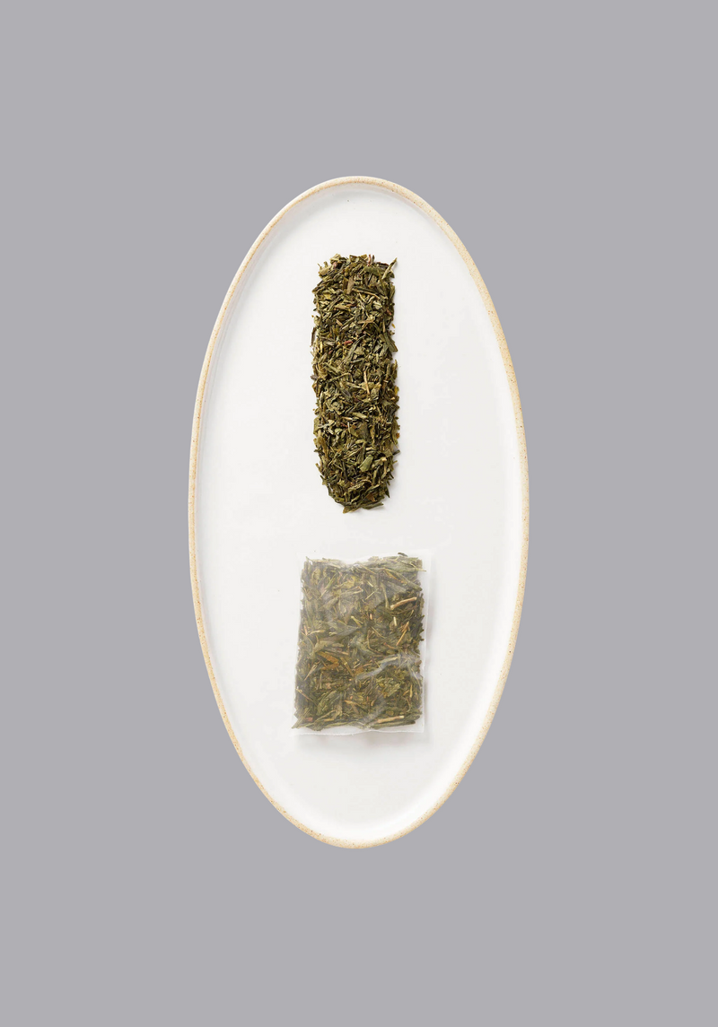 Hugo Tea Iced Green tea featuring a sachet of tea and loose tea composed on an oval plate