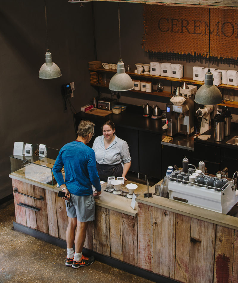 A guest interaction with a seasoned barista at Roastery location.