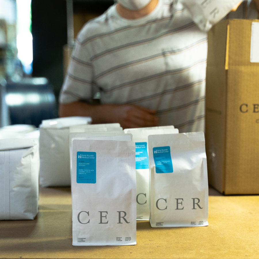 Ceremony sales rep helping to bag coffees in warehouse during Covid.