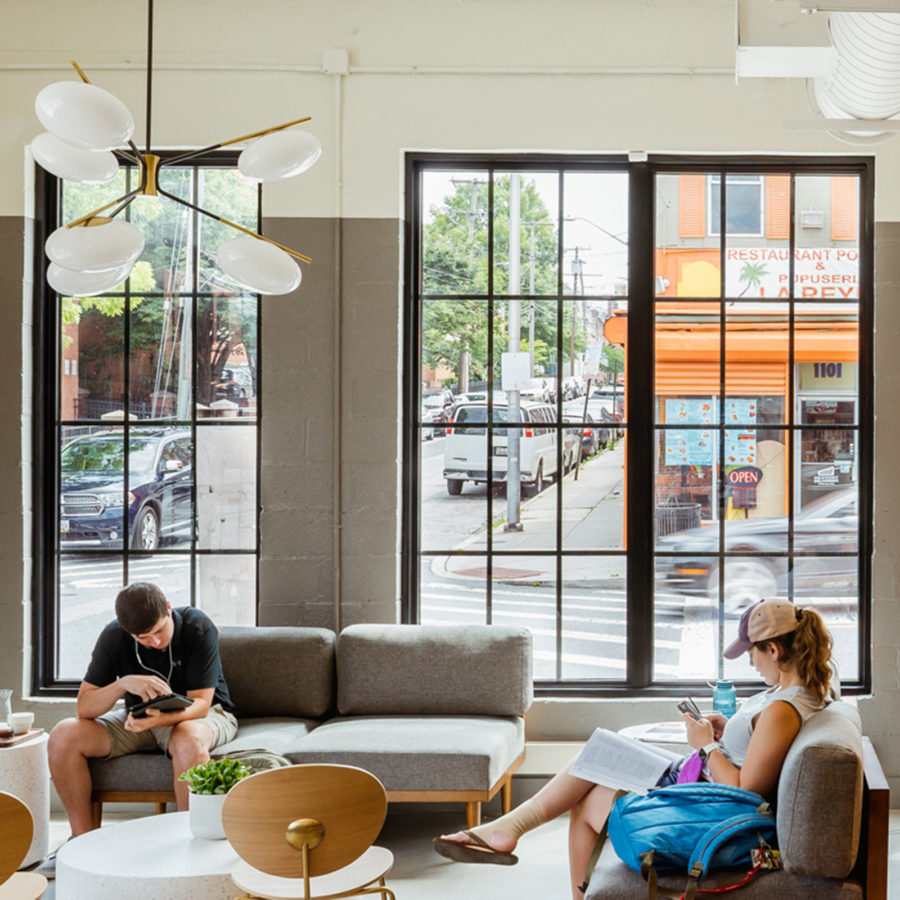 Customers reading and relaxing at Cross Street Market location.