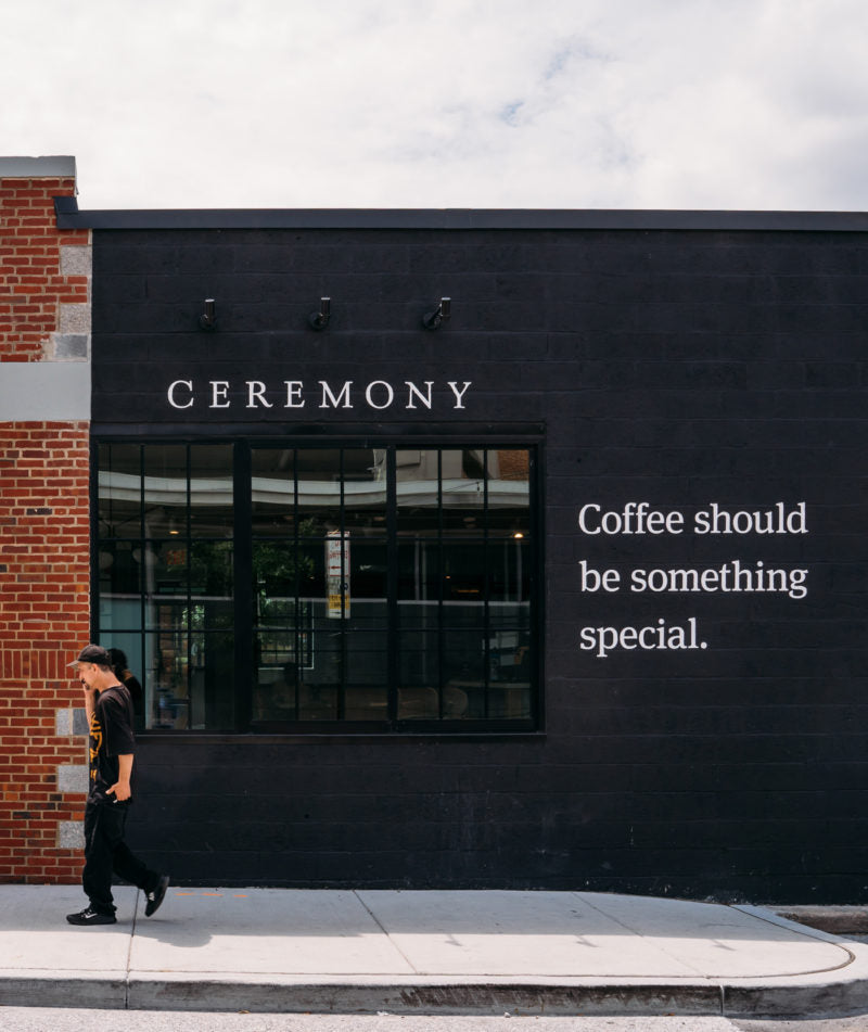 Customer walking outside Ceremony Cross Street location with the tag 