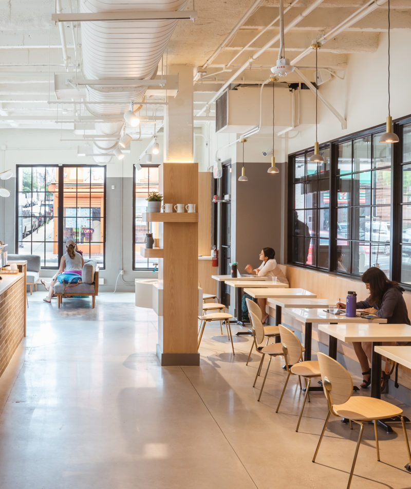 Guests working at tables inside Cross Street Market location.